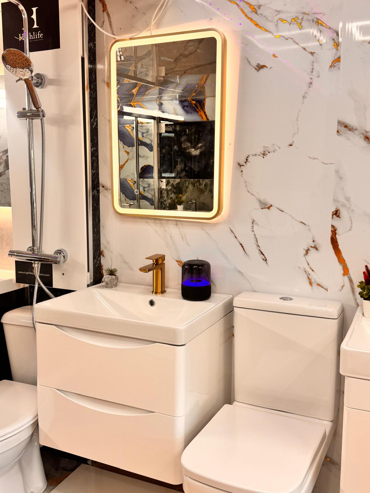 White vanity with gold mixer tap, WC and LED mirror