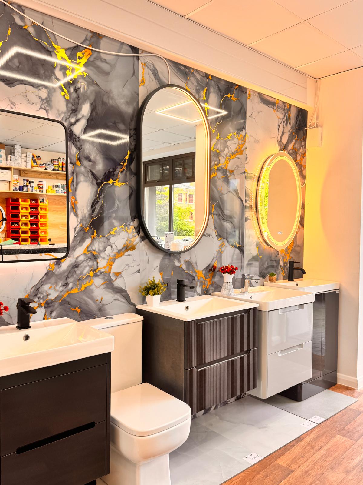 Vanity units with LED and round mirrors against marble feature wall