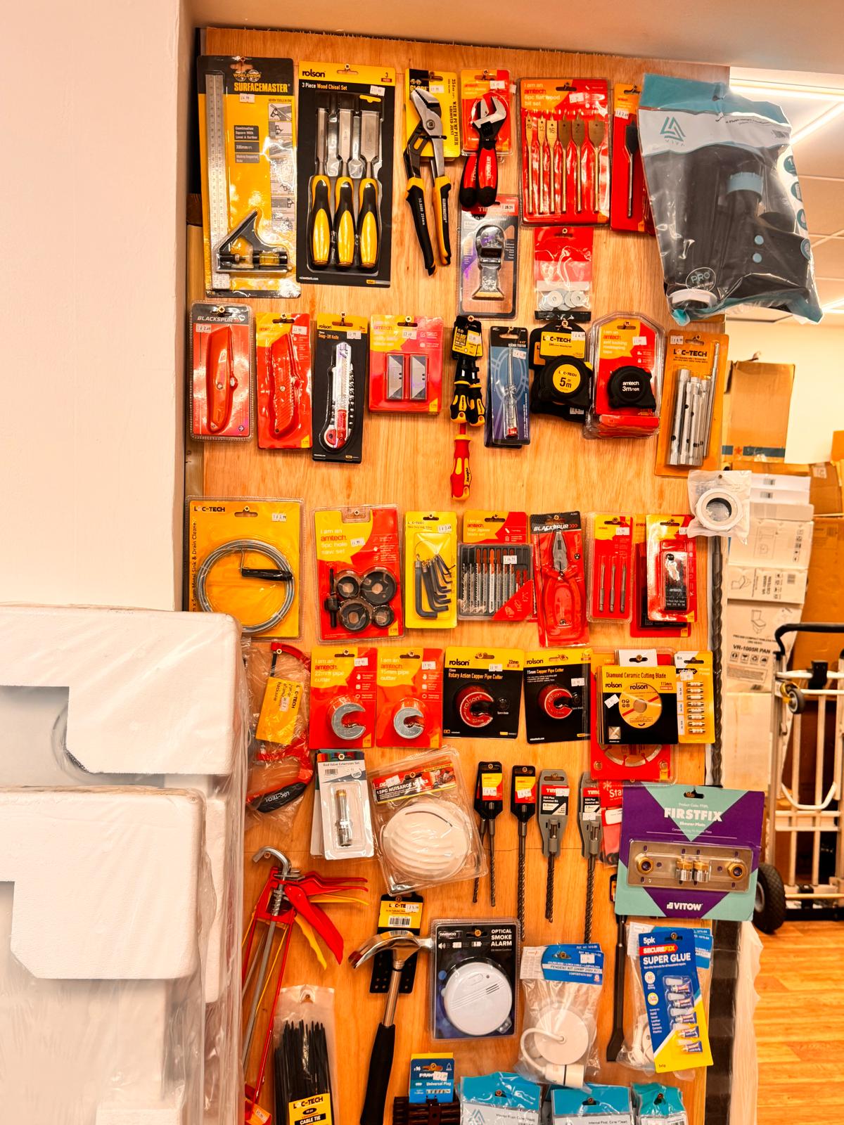 Hand tools and plumbing accessories display wall