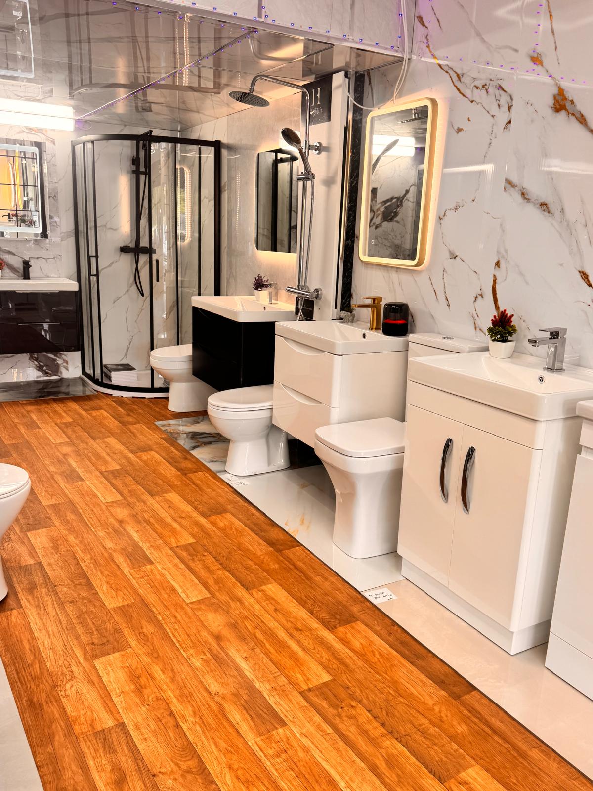 Bathroom suites on display — vanities, WCs and shower enclosure